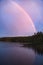 Rainbow reflected in the lake when it rains. on the lake reeds and water lilies