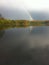 A rainbow with reflexion over the Lake Umminger, Germany.