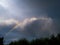 Rainbow rising out of the clouds on a summer day