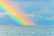Rainbow seascape after the rain above the sea waves surface