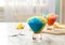Rainbow shaving ice in glass dessert bowls on marble table indoors