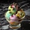 rainbow sherbet ice cream sundae bowl with chocolate chip toppings on top of marble table