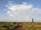 Rainbow on sky with brick factory in foreground