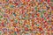 Rainbow sprinkles, colorful sugar sprinkles, background and surface