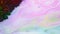 Rainbow stains on milk. Colorful pastel colors paint streaks on surface of milk. Dark powder paint hardened on surface