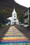 Rainbow street and Seydisfjordur church East Iceland. Colorful road