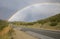 A rainbow stretching over the highway