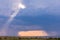 Rainbow sunrays bursting into clouds wildlife animals grazing on the savannah grasslands at the Maasai Mara National Game Reserve