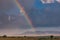 Rainbow sunrays bursting into clouds wildlife animals grazing on the savannah grasslands at the Maasai Mara National Game Reserve
