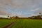 Rainbow during sunrise over rice field on cloudy day in South India