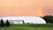 Rainbow Sunset over White Sports Dome