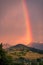 A rainbow in a sunset sky over a hill in Clarens, South Africa