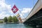 Rainbow and Swiss flags flying over the bridge in Geneva. Canton Geneva Flag. River view.Switzerland