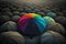 A rainbow umbrella peeks out from a sea of black umbrellas.