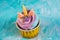 Rainbow unicorn cupcake in a yellow cup. A feast for a little princess