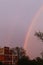 Rainbow in urban colony and purple sky