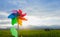 Rainbow wind turbines plastic on agricultural fields in the evening