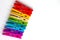 Rainbow of wooden clothespins on white background with copy space/diversity concept