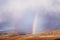 Rainbows above the wheat field in mountains - retro