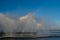 Rainbows against fountains in a technical reservoir near a thermal power plant.  Industrial tourism.