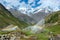 Rainbows in irrigation water spouts in Summer Alps mountain