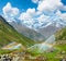 Rainbows in irrigation water spouts in Summer Alps mountain