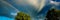 Rainbows and treetops against the backdrop of rain clouds, sunny day.Web banner