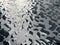 Raindrops on the black table surface that forms some abstract conceptual background