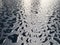 Raindrops on the black table surface that forms some abstract conceptual background