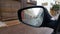 Raindrops on car rear-view mirror