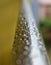 Raindrops on the chrome handrail. Rainy weather. Selective focus on the drops