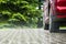 Raindrops fall on a paved area, blurred background