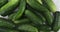 Raindrops falling on a heap of cucumbers. Rotation of cucumbers. View from above.