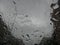 Raindrops forming streaks on a windshield