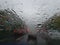 Raindrops forming streaks on a windshield