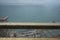 Raindrops on golden balcony railing with unfocussed sea background