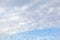 Raindrops on misted window glass against a blue sky