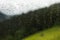 Raindrops of rain on glass of window of cottage at countryside a