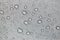 Raindrops on a water repellent gray tent surface