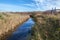 Rainham Marshes on a sunny day with a stream