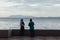 Raining in Park, Man and Woman are seeing Seascape and Cityscape from the Coast of George Town, Penang, Malaysia