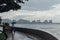 Raining in Park that near the Coast with a Man Holding Umbrella and Seeing Seascape and Cityscape of George Town, Penang, Malaysia