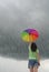 Raining wiht multicolor umbrella woman