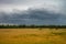 Rainstorm dark clouds is coming over countryside landscape, Thailand