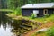 rainwater harvesting installed at a wooden lakeside cabin