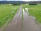 Rainwater over the road during the flooding in the green valley