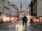 Rainy Autumn in Tallinn town blurred light on pavement  people walk with umbrellas on street Estonia Europe