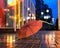 Rainy city  in city pink umbrella on asphalt night blurred light urban lifestyle