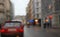 Rainy city scenery through wet windscreen