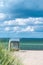 Rainy clouds above beach with blue colored roofed chairs in Travemunde. Germany